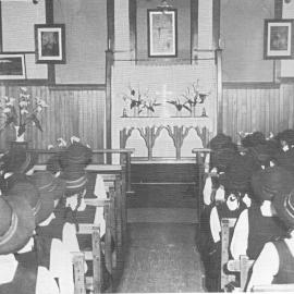 Hukarere students attending a worship service in the old chapel, wearing hats and gym tunics. 