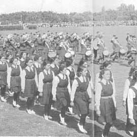 Hukarere students marching with a band and many others on a showground (?)