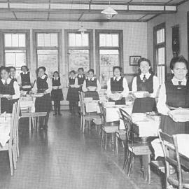 Hukarere students in the dining room standing ready to serve a table