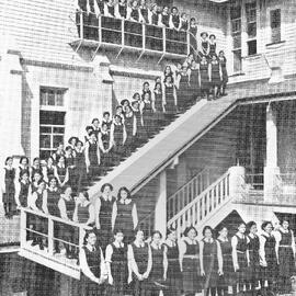 Hukarere School students standing on the balcony and stairs of the wooden school building