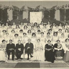 Debutante group. Banner in background reads 'Te Rau-Aroha Diocese Waikato'