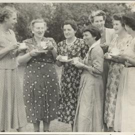 Mother’s Union group with tea-cups, caption reads ‘chatting informally’